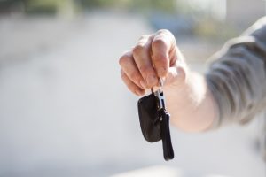 Man extending his arms to give car keys